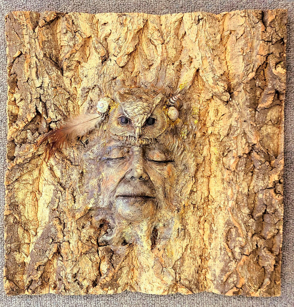 Detail view of Owl Spirit of the Forest sculpture showing bark texture and carved owl form