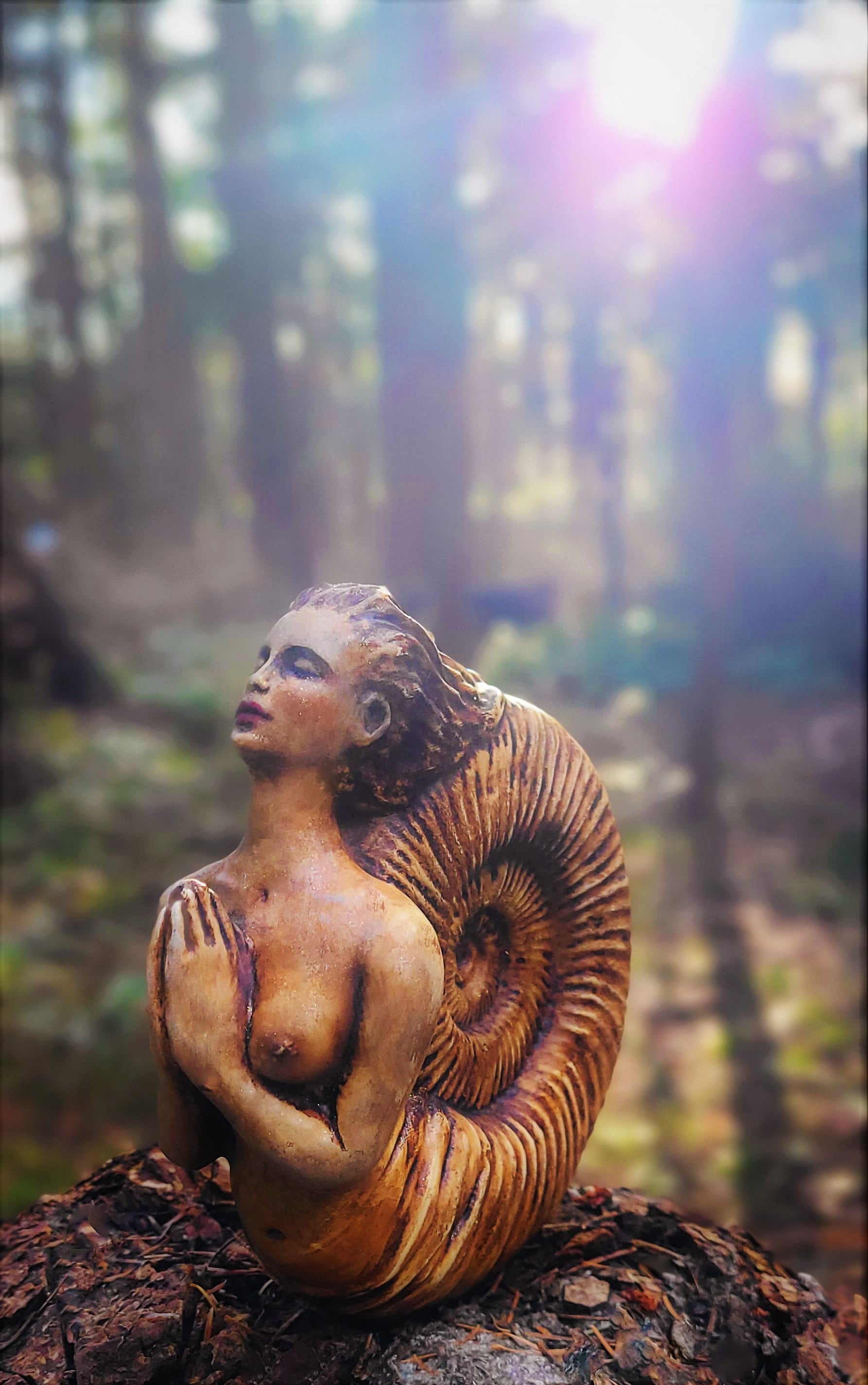 Close up of spiral fossil texture on Ammonite Woman sculpture highlighting hand finished detail