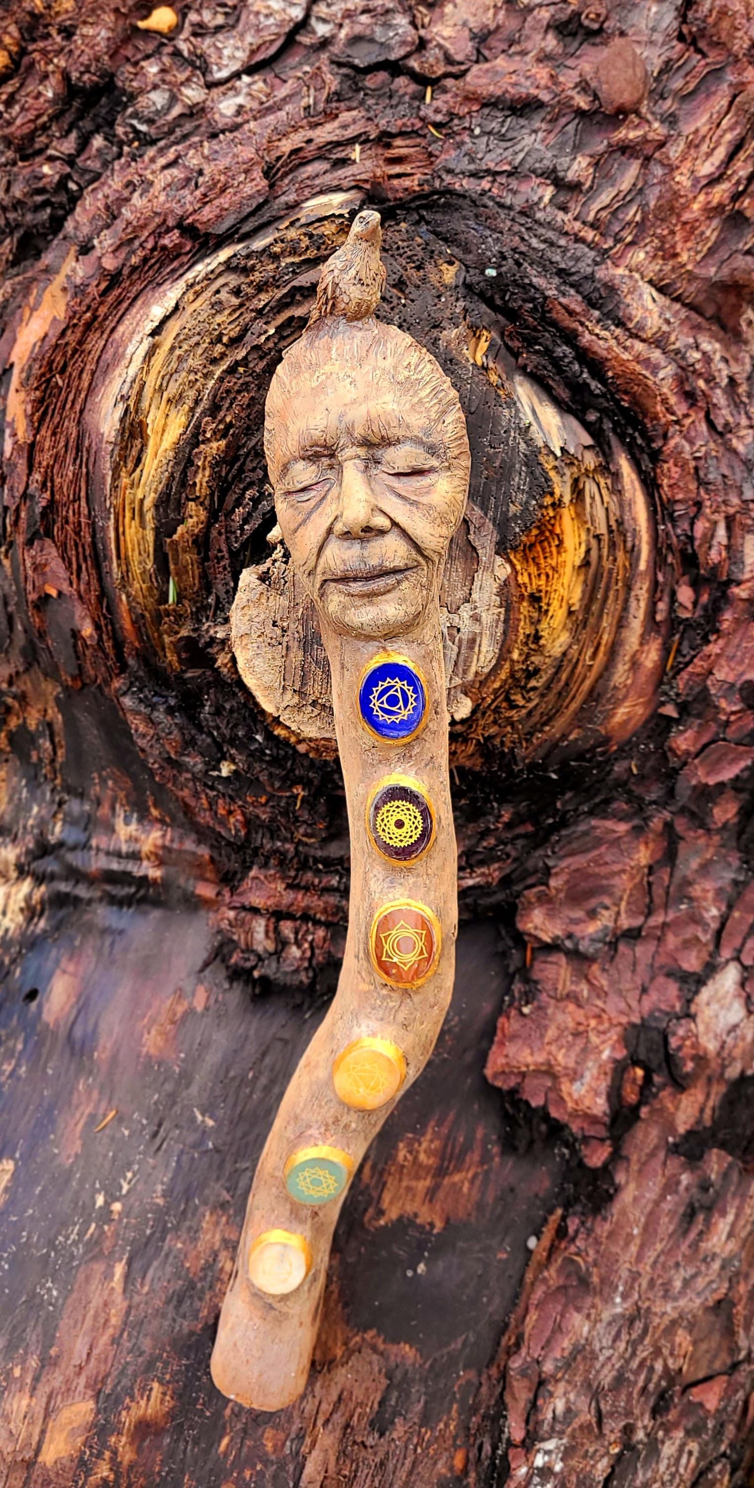 Sculpture with chakras and resting on their head