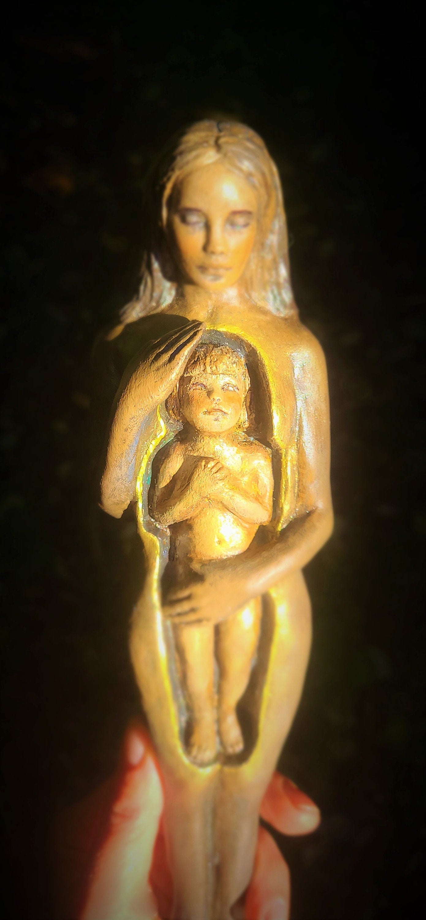 Close up of hand finished surface texture on Inner Child sculpture highlighting organic craftsmanship