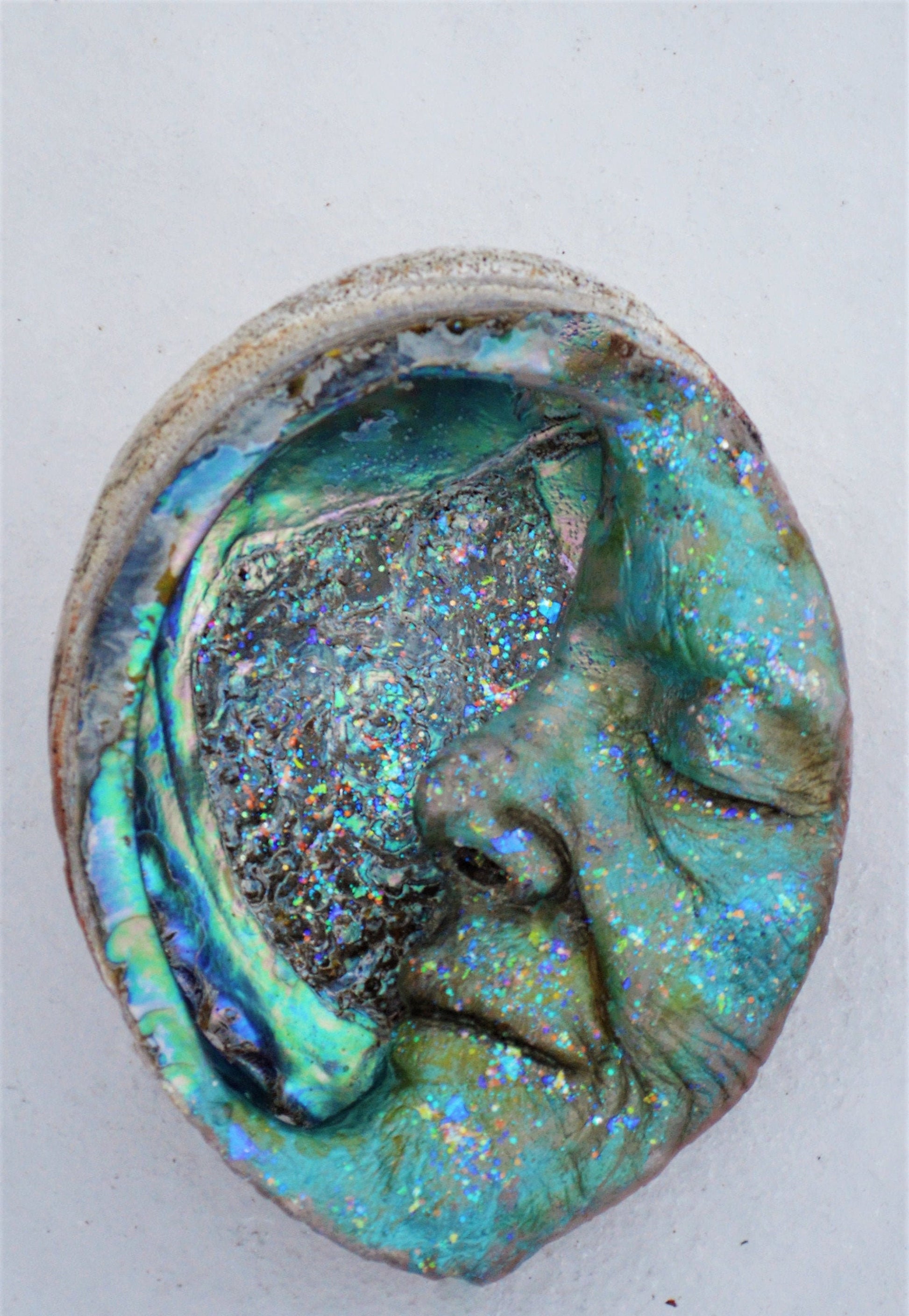 Moon Keeper abalone moon sculpture styled in spiritual home decor and meditation space