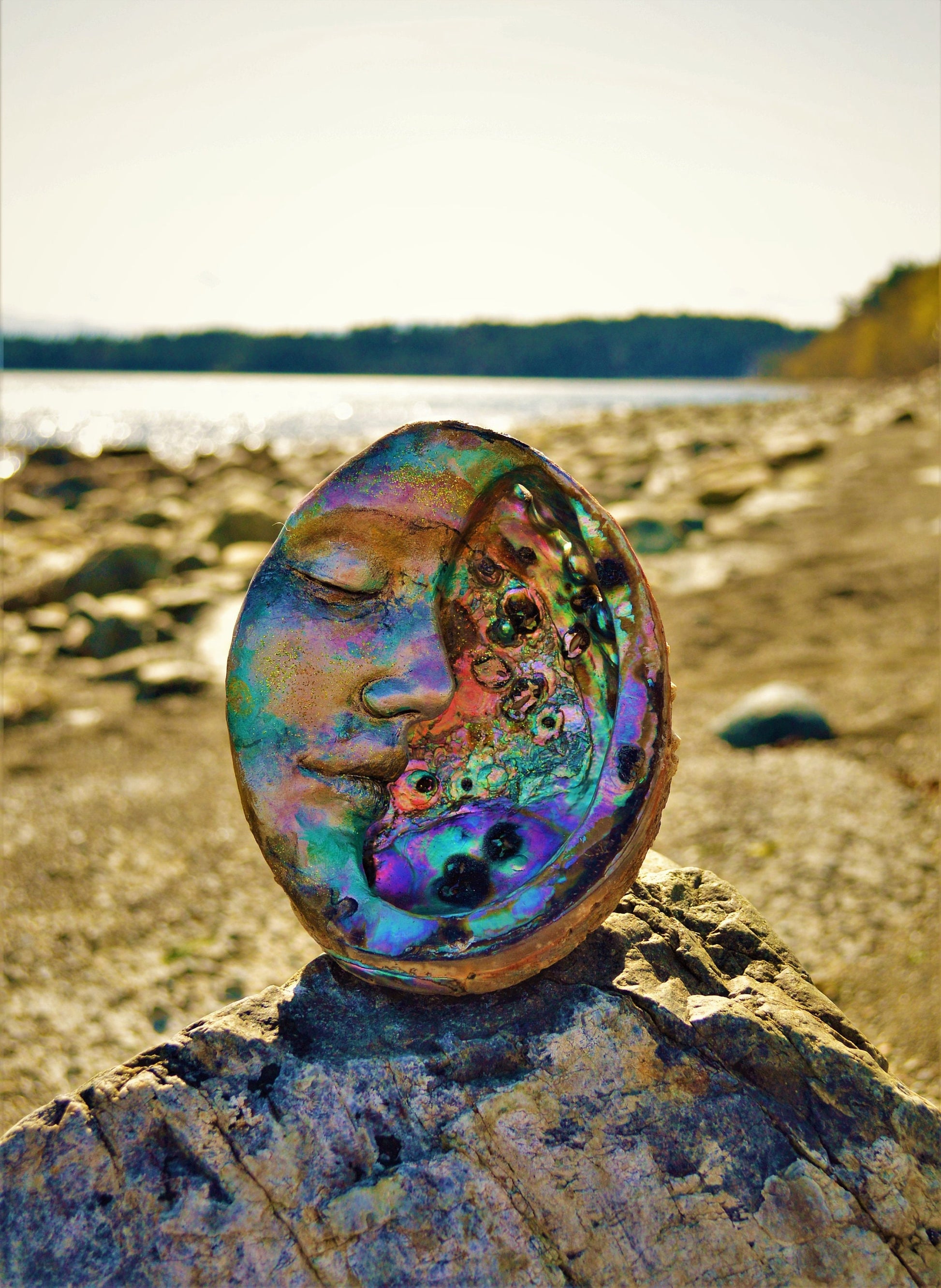 Side view of Moon of New Beginnings abalone moon sculpture showing curved moon form and shell inlay