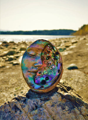 Side view of Moon of New Beginnings abalone moon sculpture showing curved moon form and shell inlay