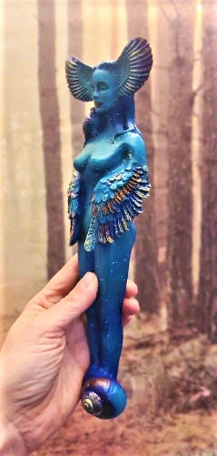 Side view of Owl Goddess sculpture showing flowing feminine form and carved owl detail