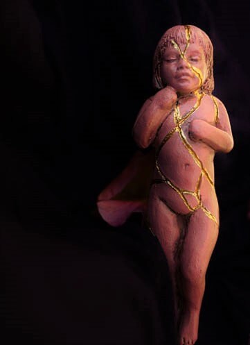 Close up of gold kintsugi repair detail on Pink Kintsugi sculpture representing healing and resilience