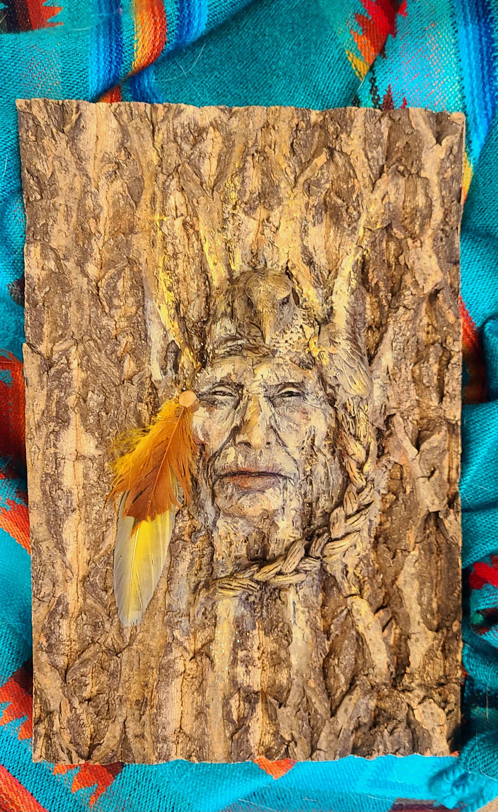 Side view of Raven Spirit of the Forest sculpture showing carved raven form and bark texture