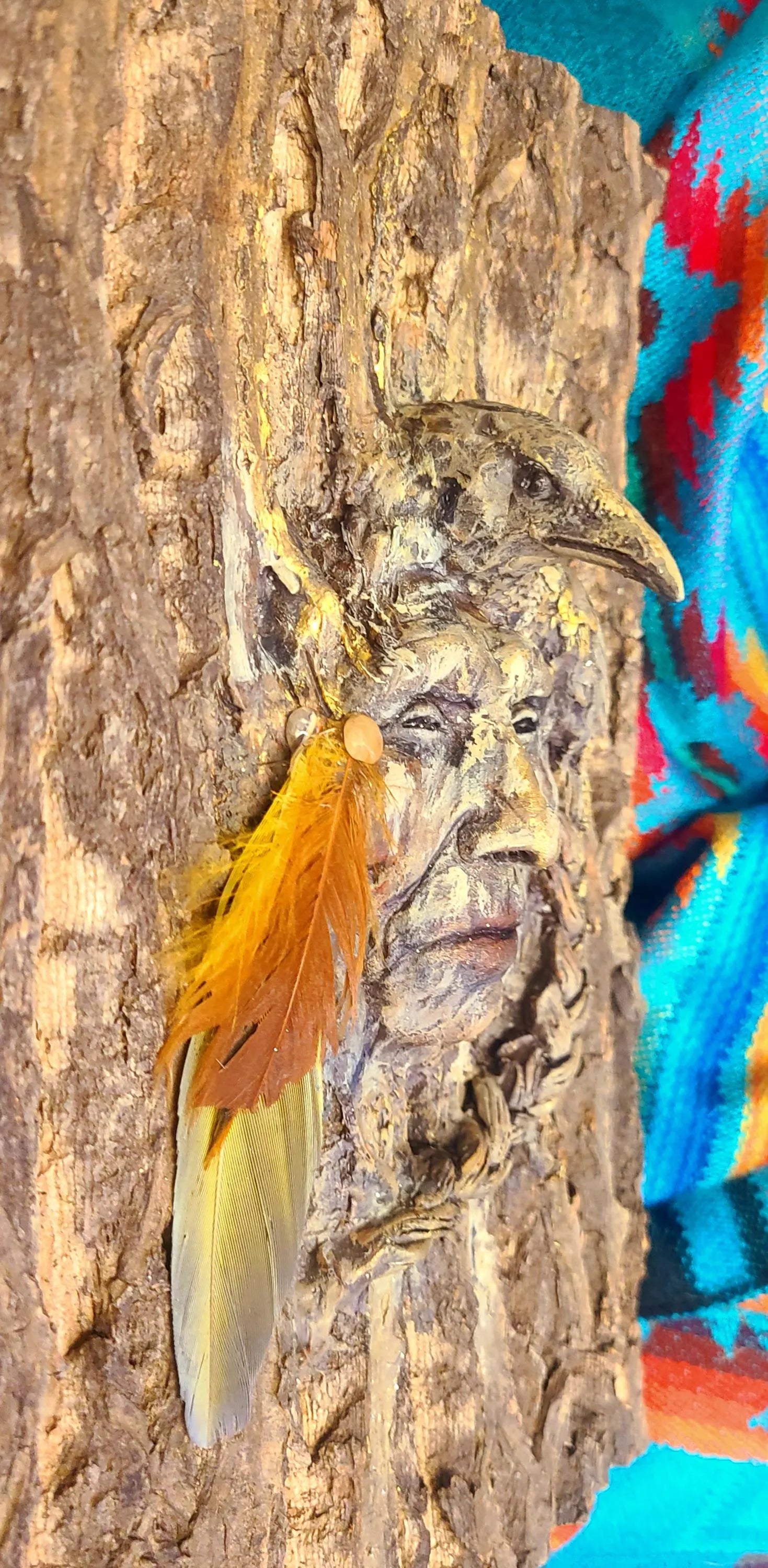 Close up detail of bark texture and raven carving on Raven Spirit of the Forest sculpture