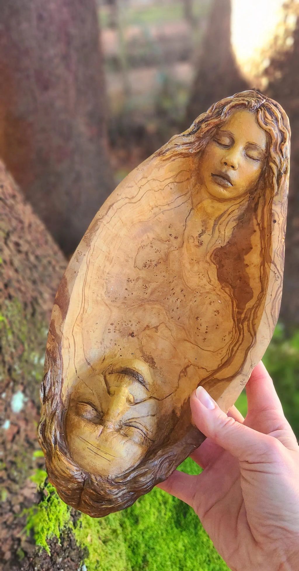 Side view of The Lives We Live wooden bowl sculpture showing grandmother and granddaughter figures