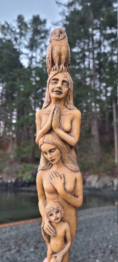 Side view of Totem of Woman tan sculpture showing layered totem form and natural surface texture