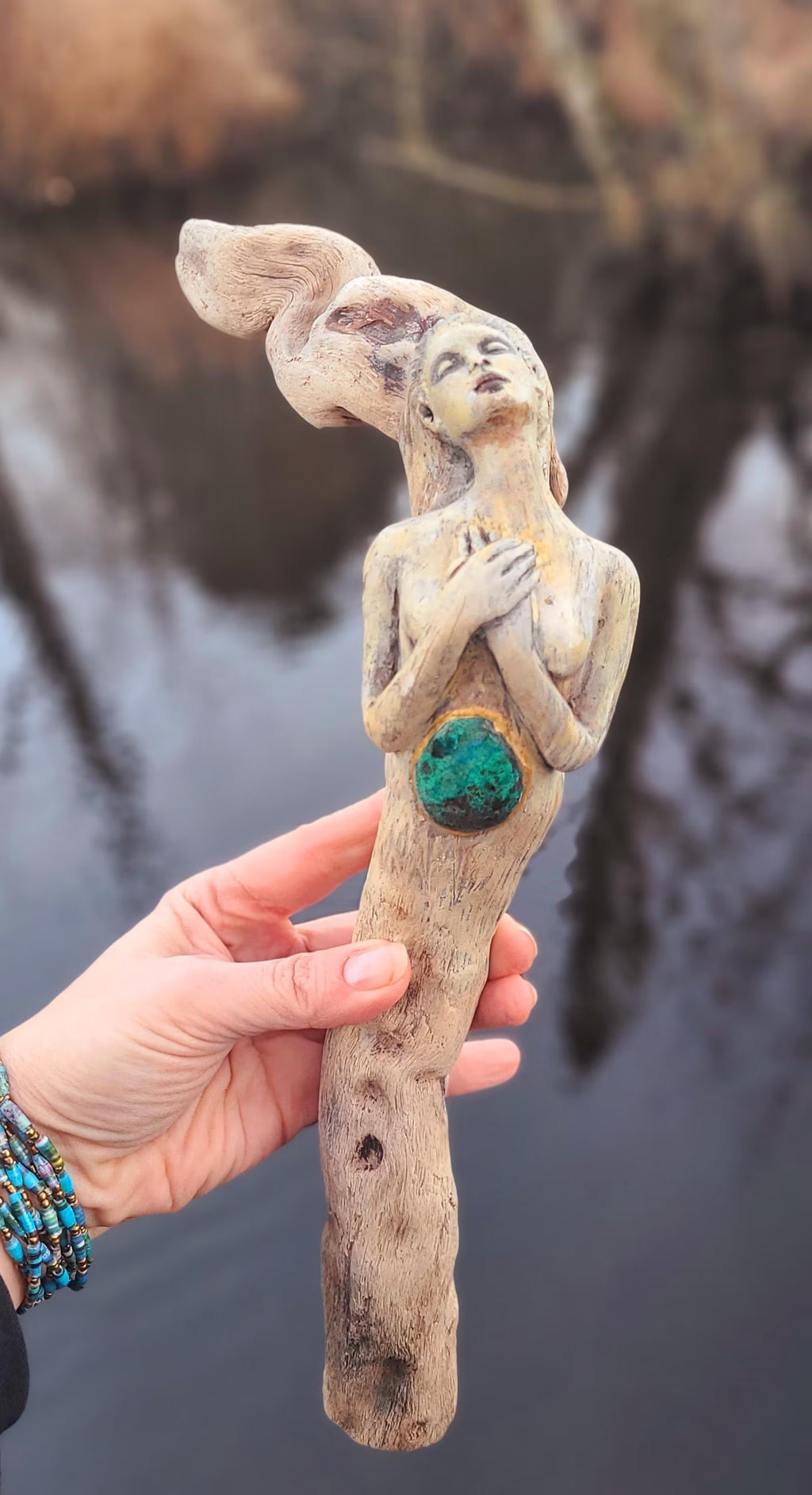 Side view of We Find the Way root woman sculpture showing organic wood texture and turquoise detail