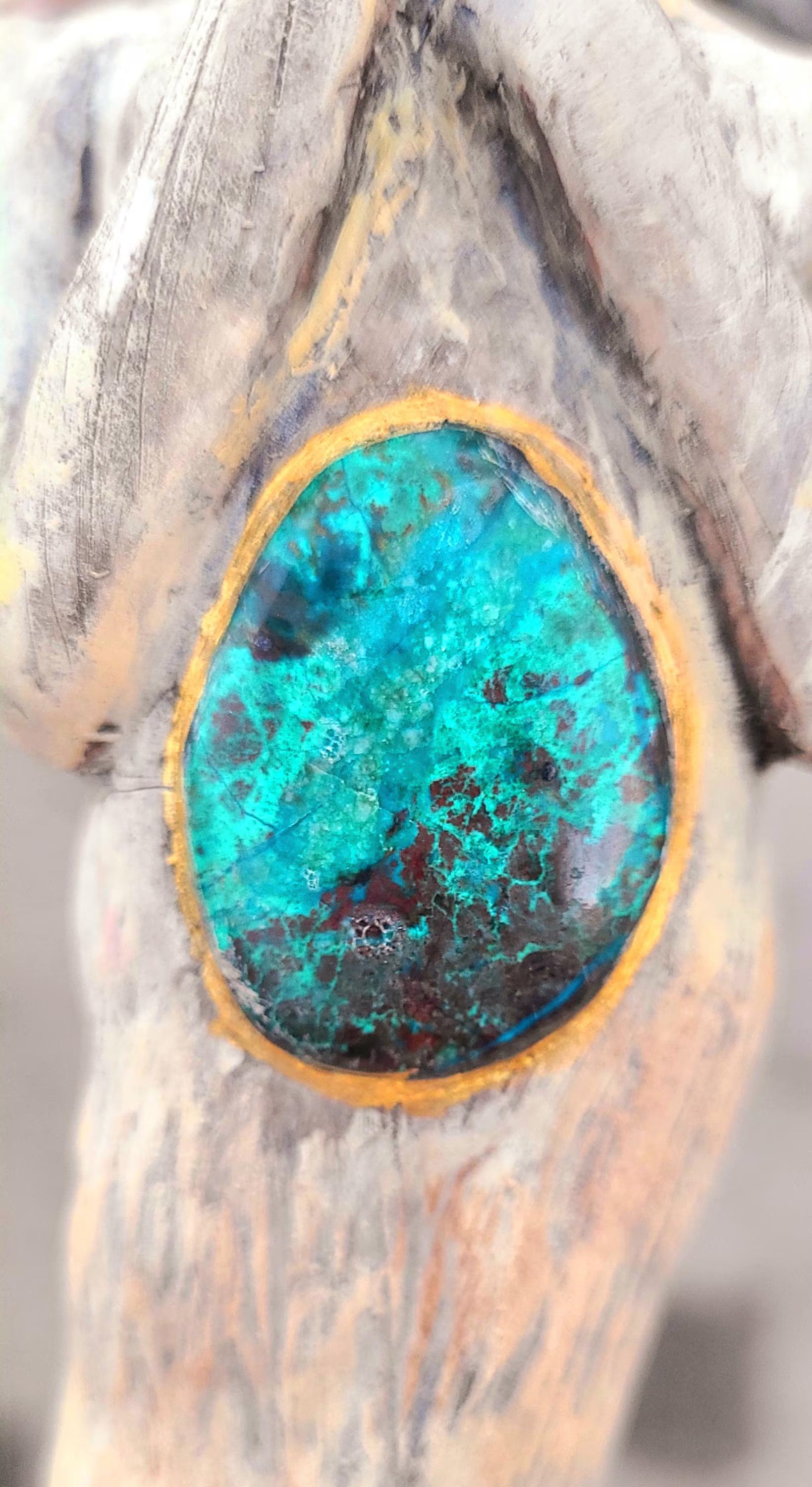 Close up of turquoise stone and wood texture on We Find the Way handmade root woman sculpture